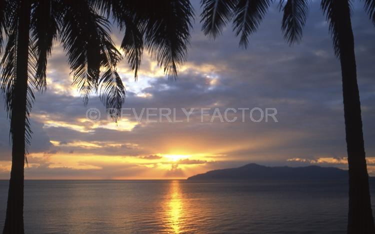 Island Sunsets;Papua New Guinea;sky;sillouettes;sunset;water;red;colorful;yellow;ocean;palm trees